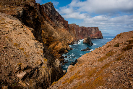 panorama of Ponta de Sao Lourenco promontory between lava mountains and sunburned meadows with waves crashing on lava rock cliffs in Madeira Portugalの写真素材