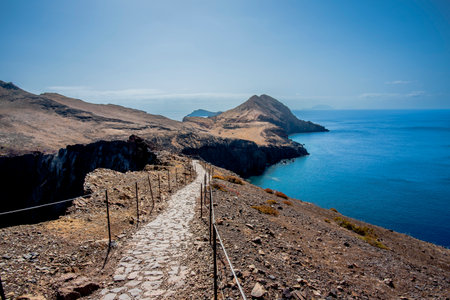 panorama of Ponta de Sao Lourenco promontory between lava mountains and sunburned meadows with waves crashing on lava rock cliffs in Madeira Portugalの写真素材