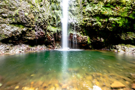 typical Waterfall among the Levadas of Madeira Portugal, water channel built at the peak of the...