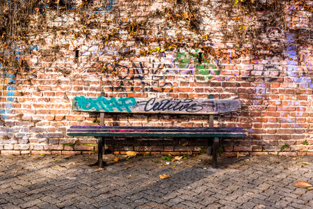 empty bench on bricks wall with evy in Turin Italyの写真素材