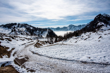 mountain road with snow between dolomite peaks and Campogrosso alpine mountains Vicenza Veneto Italyの写真素材
