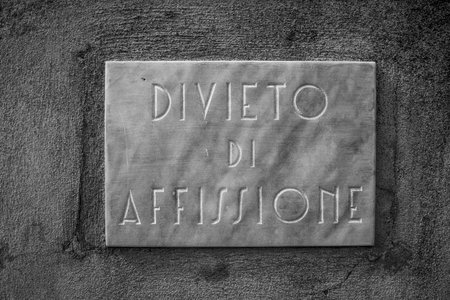 marble plaque from the 1920s with the writing prohibition of posting in Orgiano Vicenza Veneto Italyの写真素材