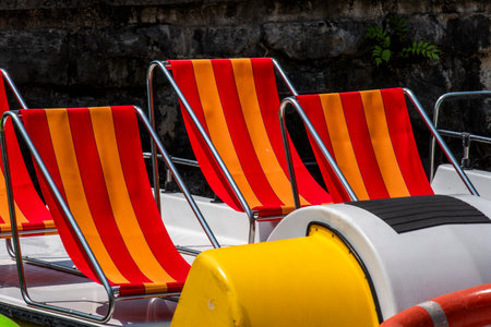 striped deckchair on the pedal boat in Garda on Lake Gardaの写真素材