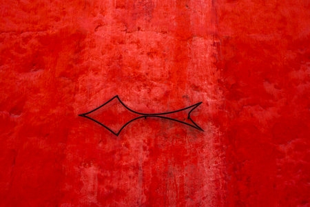 arrow pointing directions with arrow on blue and red wall in Cuzco Inca city in Peruの写真素材