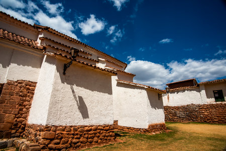 detail of a small village in the mountains of the Andes with brown stone streets, white houses and squares with the market in Peru in South Americaの写真素材