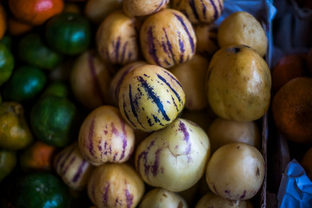 Solanum muricatum Aiton piled up on market stalls in Cusco in Peru in South America