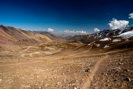 panorama of peaks and valleys with plateaus blue sky and white clouds in the background glaciers in the Andean mountains of Peru near Ausangate in the Cusco region of Peru in South Americaの写真素材