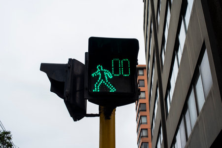 green traffic light with counter for pedestrians in Lima in Peru in South Americaの写真素材
