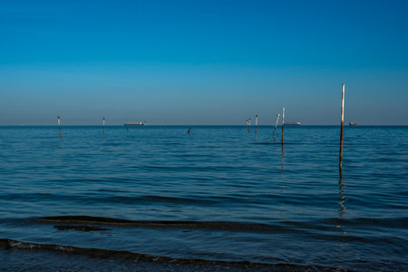 calm sea in winter transparent and wavy green color near the sandy beaches of Lido di Venezia in...