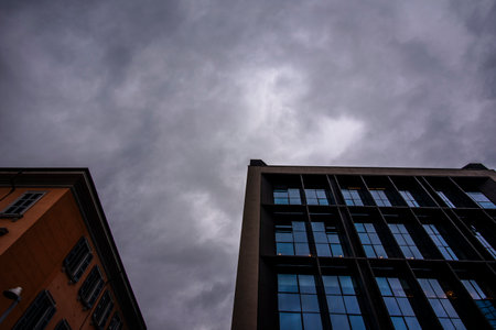 geometries of windows and buildings with sky and electric wires in the streets of Milan in Italyの写真素材