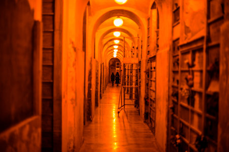 interior view of a corridor with soft yellow and orange lights inside a cemetery