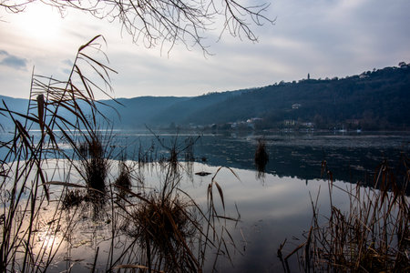 panorama of Fimon lake among the calm and quiet waters on an autumn day among trees and hills of Fimon lake in Vicenzaの写真素材