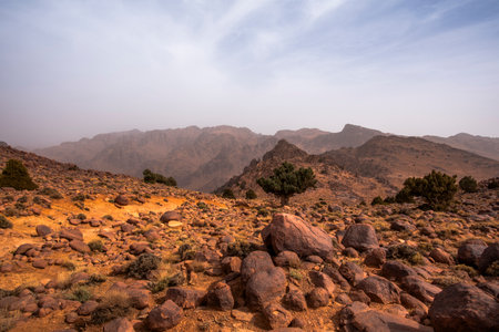 orange volcanic rocks and desert Atlas panorama in the mountains in the heights near Jebel Saghro between the desert and Marrakesh in Moroccoの写真素材