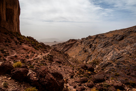 rocky trail between the mountain peaks of the Moroccan Atlas with desert valleys among the Berber...