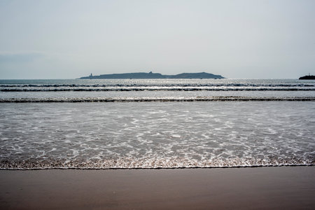 beautiful beach of Essaouira with surfers and waves that die on the beaches of Moroccoの写真素材