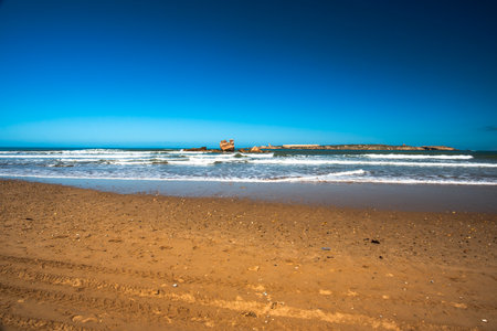 beautiful beach of Essaouira with surfers and waves that die on the beaches of Moroccoの写真素材