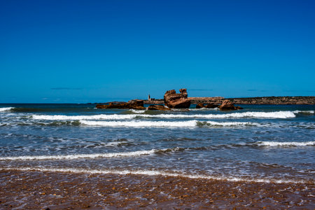 beautiful beach of Essaouira with surfers and waves that die on the beaches of Moroccoの写真素材