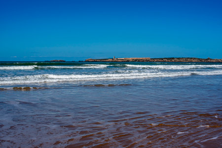beautiful beach of Essaouira with surfers and waves that die on the beaches of Moroccoの写真素材