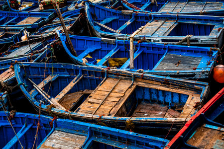 blue fishing boats docked in Essaouira port in Moroccoの写真素材
