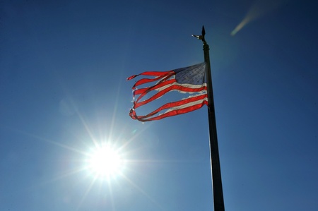 NEW YORK, NY - NOVEMBER 09: An American ripped flag flies from the front yard of a house in a damaged area November 9, 2012 in the Breezy Point part of Far Rockaway in the Queens borough of NY.のeditorial素材