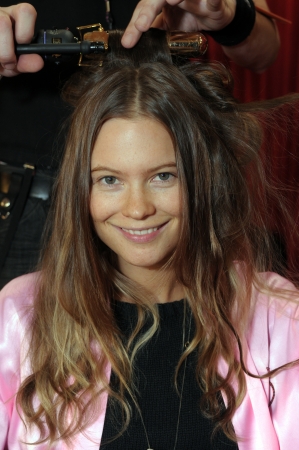 NEW YORK - NOVEMBER 10: Victoria's Secret model  Behati Prinsloo getting ready backstage  during the 2010 Victoria's Secret Fashion Show on November 10, 2010 at the Lexington Armory in New York City. のeditorial素材