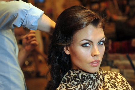 Warm light beauty shoot of brunette model in Beauty salon interior during hairstyling processのeditorial素材