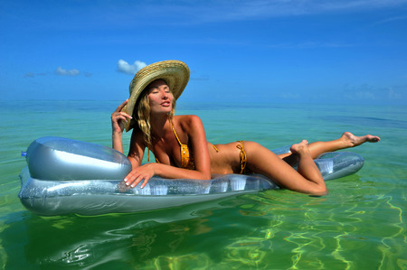 Sexy girl resting at mattress at tropical waterのeditorial素材