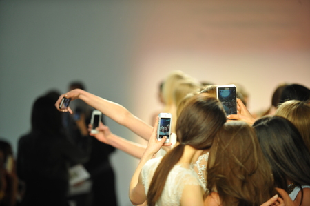NEW YORK, NY - APRIL 11: Models and guests take pictures on the phones  during the RIVINI Spring 2015 Bridal collection show at on April 11, 2014 in New York City.のeditorial素材