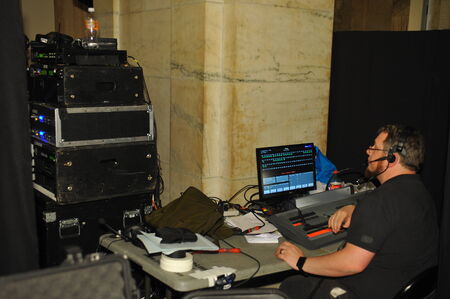 Sound and light engeneer at fashion show production booth