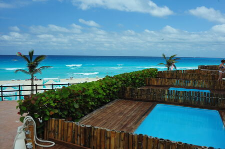 Tropical ocean view in the middle of sunny day in Cancun Mexico from private room poolのeditorial素材