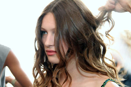 NEW YORK, NY - June 16: A hair stylist getting model ready backstage at the Claire Pettibone Spring 2015 Romantique Bridal collection show on June 16, 2014 in NYC.のeditorial素材