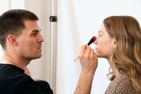 NEW YORK, NY - June 16: A makeup artist applying makeup to model face backstage at the Claire Pettibone Spring 2015 Romantique Bridal collection show on June 16, 2014 in NYC.のeditorial素材