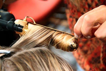 NEW YORK, NY - June 16: A hair stylist getting model ready backstage at the Claire Pettibone Spring 2015 Romantique Bridal collection show on June 16, 2014 in NYC.のeditorial素材