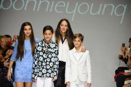 NEW YORK, NY - OCTOBER 19: Designer Bonnie Young poses with Celia Babini, Kyah Cahill and Brando Babini on the runway during the Bonnie Young preview at petitePARADE Kids Fashion Week on October 19, 2014 in NYC.のeditorial素材
