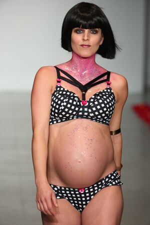 NEW YORK, NY - OCTOBER 25: A pregnant model walks runway during You! Lingerie Spring 2015 show during Lingerie Fashion Week at the Center 548 on October 25, 2014 in New York City.のeditorial素材