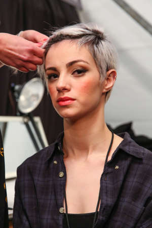 NEW YORK, NY - FEBRUARY 15: A model getting ready backstage at the FTL Moda fashion show during MBFW Fall 2015 at The Salon at Lincoln Center on February 15, 2015 in NYC.のeditorial素材