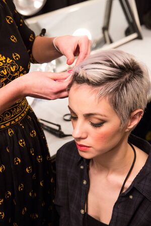 NEW YORK, NY - FEBRUARY 15: A model getting ready backstage at the FTL Moda fashion show during MBFW Fall 2015 at The Salon at Lincoln Center on February 15, 2015 in NYC.のeditorial素材