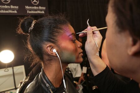 NEW YORK, NY - FEBRUARY 15: A model getting ready backstage at the FTL Moda fashion show during MBFW...