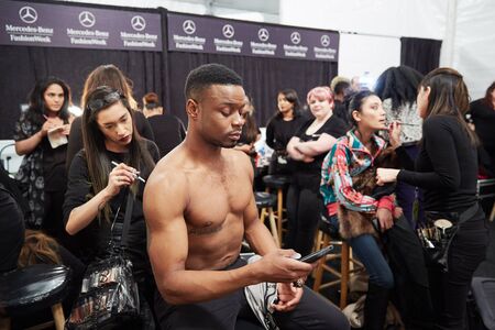 NEW YORK, NY - FEBRUARY 19: A model getting ready backstage at the New York Life fashion show during MBFW Fall 2015 at Lincoln Center on February 19, 2015 in NYC.のeditorial素材