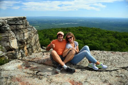 Couple sitting on the rock at Minnewaska State Park Reserve Upstate NY during summer timeの写真素材