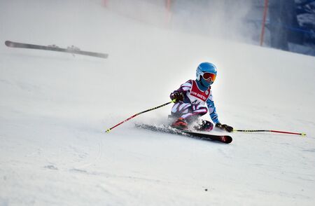 LOON MOUNTAIN USA - JANUARY 24: Tina Sutton Memorial. Unidentified participant felt down and lost one ski during junior ski race on January 24, 2016 at the Loon Mountain in NH, USAのeditorial素材
