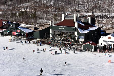 LOON MOUNTAIN USA - JANUARY 24: Tina Sutton Memorial - Slalom Ski Competition. Loon mountain lodge view from lift chair during junior ski race on January 24, 2016 at the Loon Mountain in NH, USAのeditorial素材