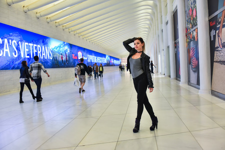 Model posing at the hall with visual perspective shot of WTC subway station in  NYC.
