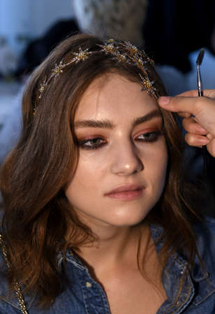 New York, NY, USA - October 6, 2017: A model getting ready backstage before Berta Bridal 2018 Collection runway show during New York Bridal week, New York City.のeditorial素材