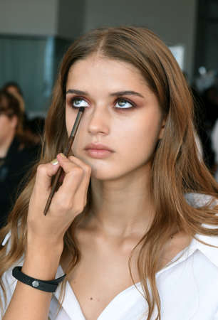 New York, NY, USA - October 6, 2017: A model getting ready backstage before Berta Bridal 2018...
