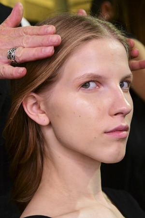 MILAN, ITALY - SEPTEMBER 25: A model getting ready backstage before the Ssheena show during Milan Fashion Week Spring/Summer 2018on September 25, 2017 in Milan, Italy.のeditorial素材