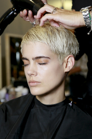 MILAN, ITALY - SEPTEMBER 24: A model getting ready  backstage before the Mila Schon show during Milan Fashion Week Spring/Summer 2018 on September 24, 2017 in Milan, Italy.のeditorial素材