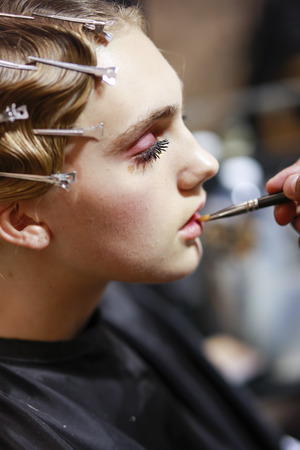 MILAN, ITALY - SEPTEMBER 21: A model is getting ready backstage before the Les Copains show during Milan Fashion Week Spring/Summer 2018on September 21, 2017 in Milan, Italy.のeditorial素材