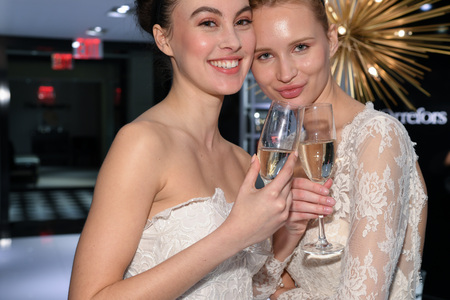 NEW YORK, NY - APRIL 10: Models Milena Garbo (R) and Heather Aboff (L) presenting dresses during the Gracy Accad Spring 2020 bridal presentation at Blumingdales store on April 10, 2019 in NYC.のeditorial素材
