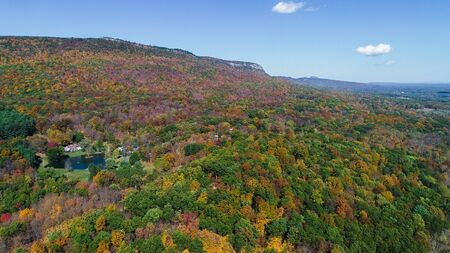 Top view aerial autumn mountain forest beautiful landscape.Travel and touristic wallpaper concept photographyの写真素材